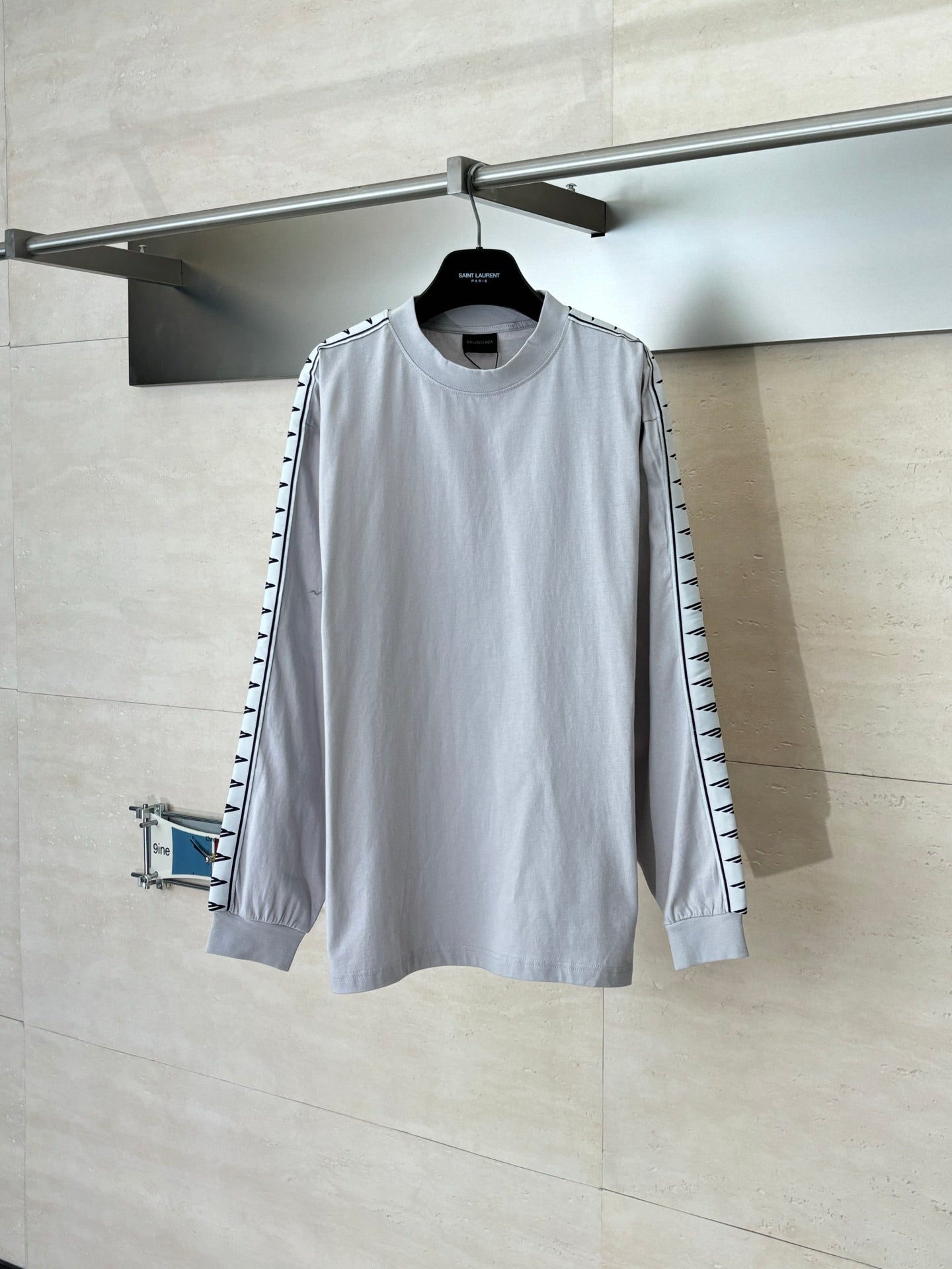 Light gray long-sleeve crewneck top with graphic stripe panels on sleeves
