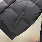 Dark puffer jacket sleeve with zipper pocket detail
