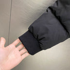 Dark puffer jacket sleeve cuff with ribbed knit hem