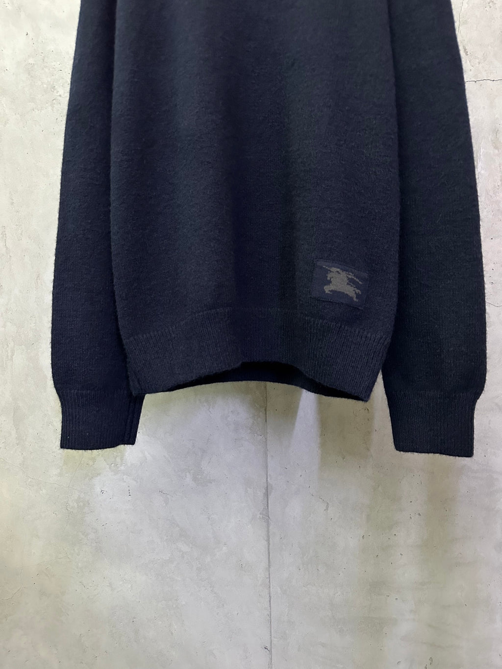 Navy crewneck knit sweater with small chest logo patch