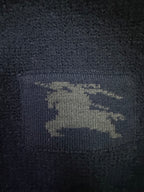 Navy knit sweater with visible Burberry horse logo patch