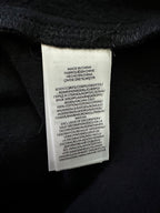 Black sweatshirt care label sewn at inside neckline
