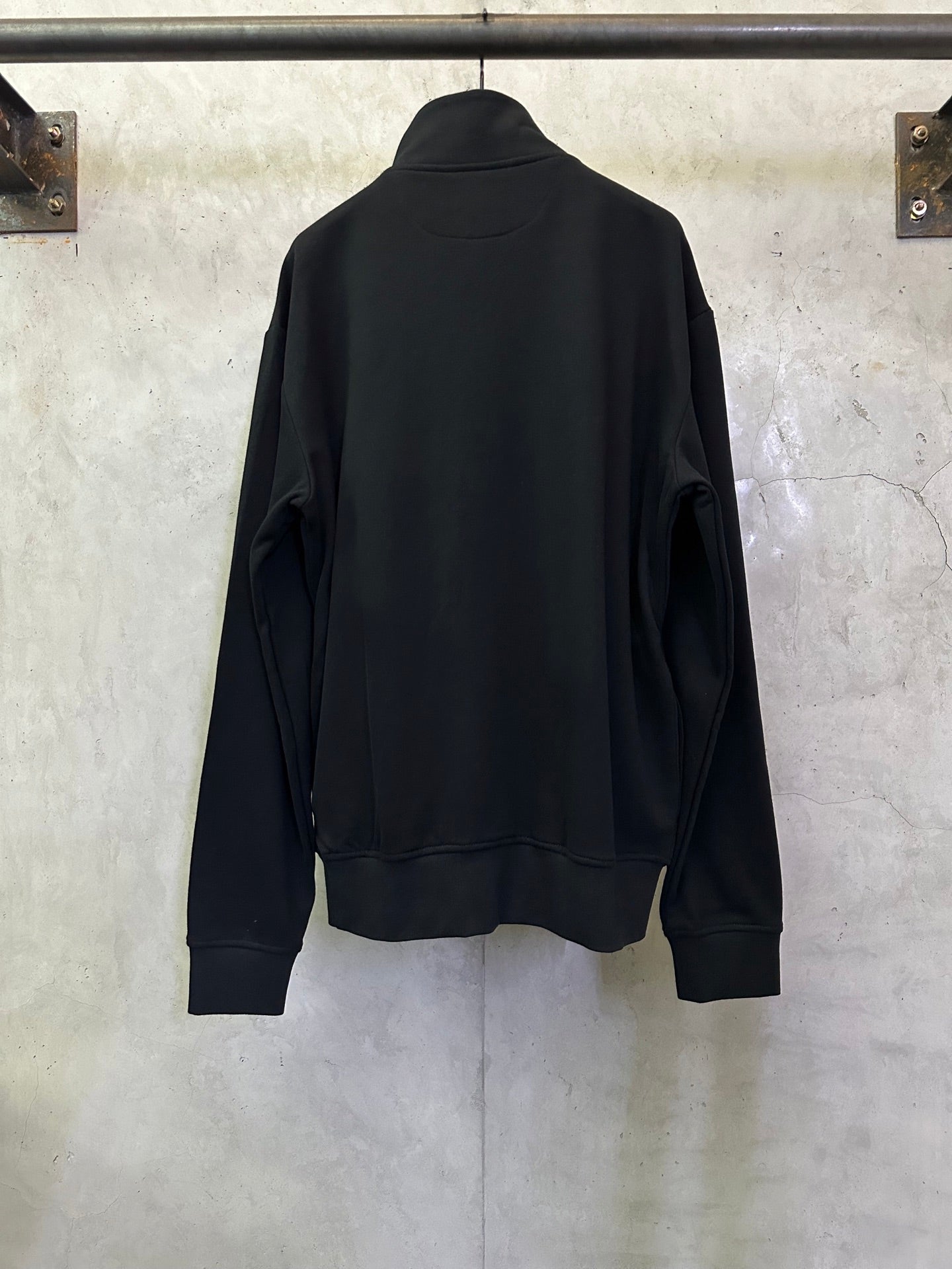 Black quarter-zip sweatshirt back view, high collar and relaxed fit