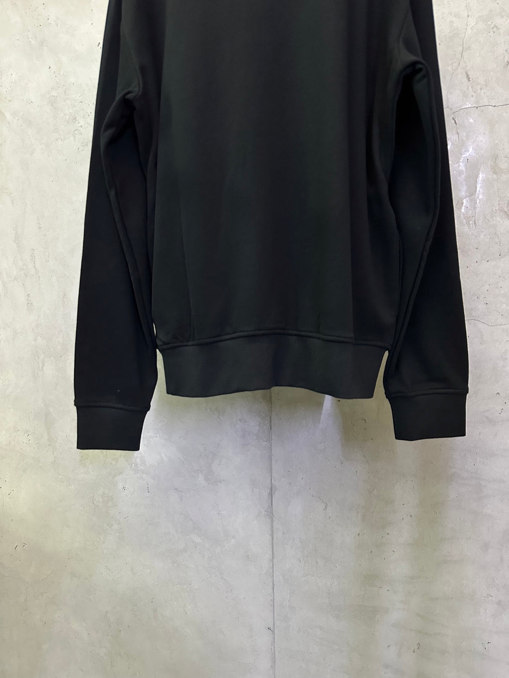 Black quarter-zip sweatshirt back view with ribbed hem and cuffs