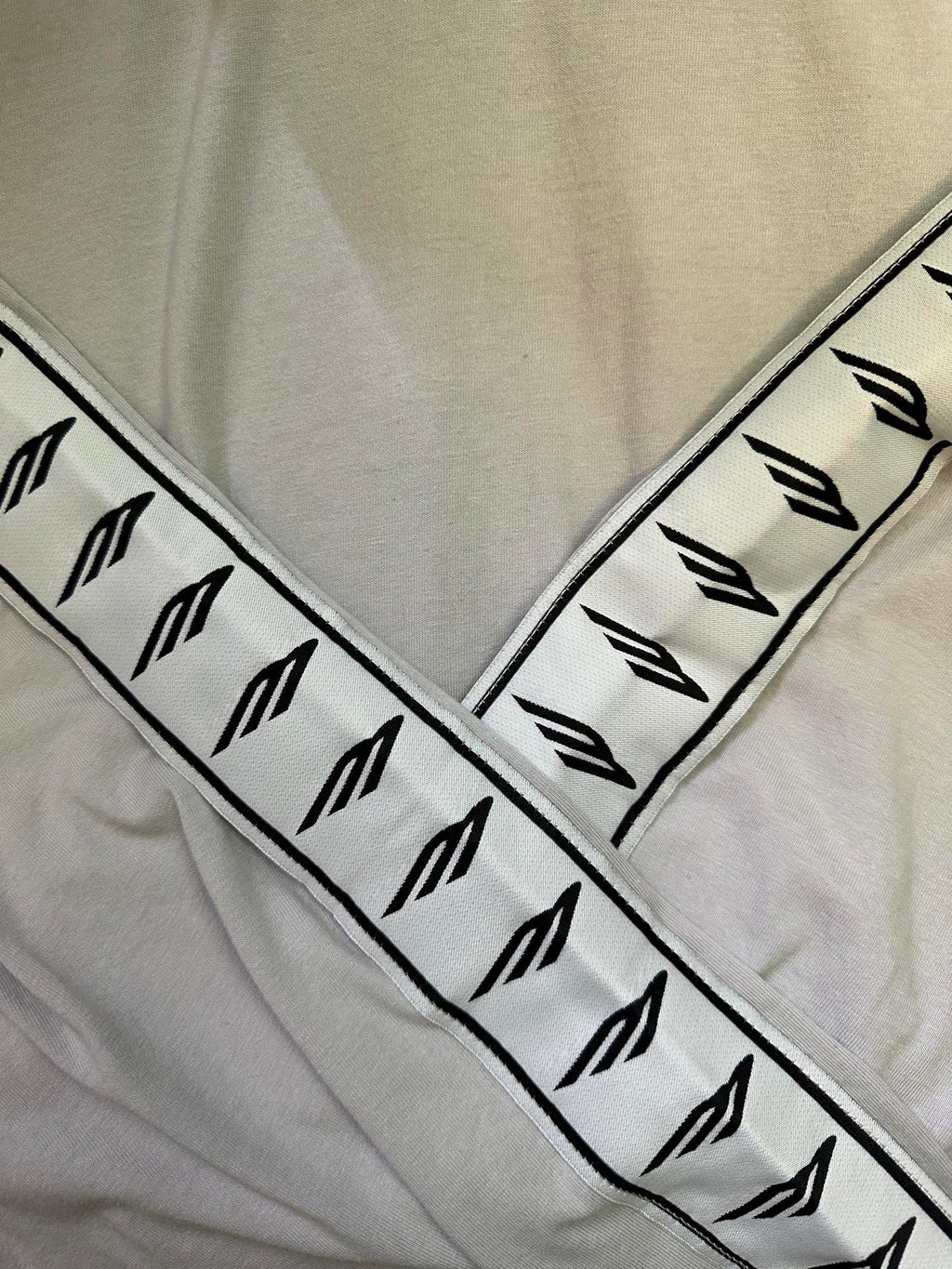 Balenciaga sleeve logo band, black symbols on light off-white fabric