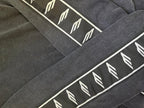 Long-sleeve shirt sleeve stripe in dark gray with white repeating logo symbols
