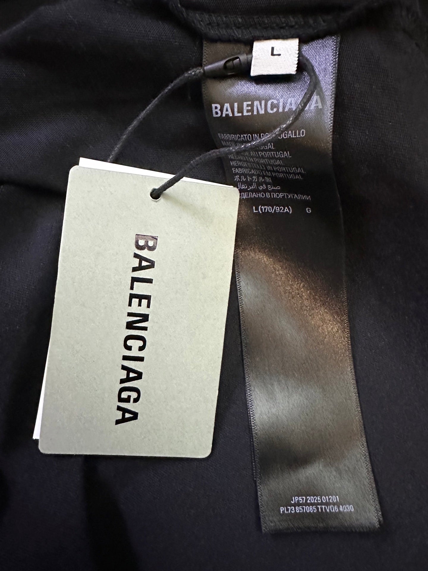 Balenciaga size and clothing tags on dark gray long-sleeve shirt
