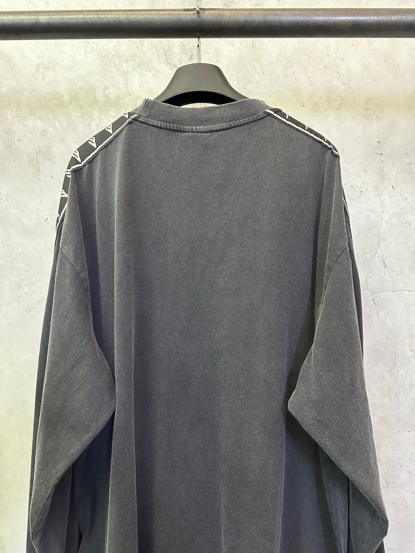 Balenciaga long-sleeve shirt, dark gray back view with white logo tape at shoulders