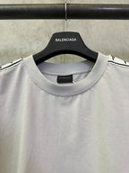 Light gray crew-neck T-shirt with Balenciaga logo at collar and black shoulder trim