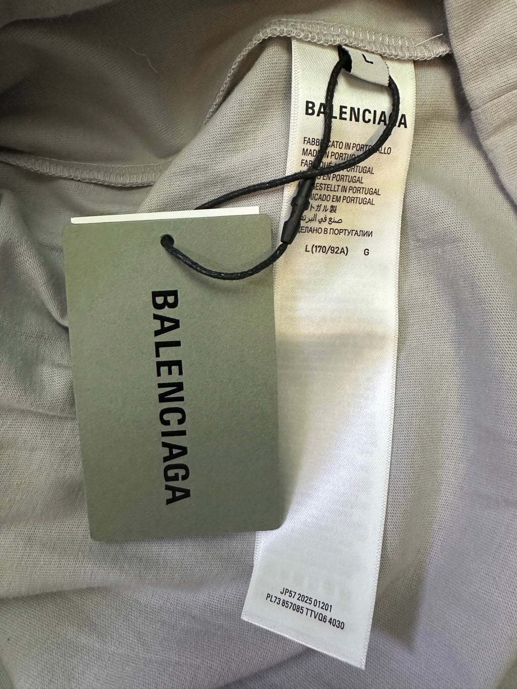 T-shirt hang tags with Balenciaga logo on paper tag and size label