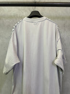 Light gray short-sleeve T-shirt back view with black logo-trim accents on shoulders