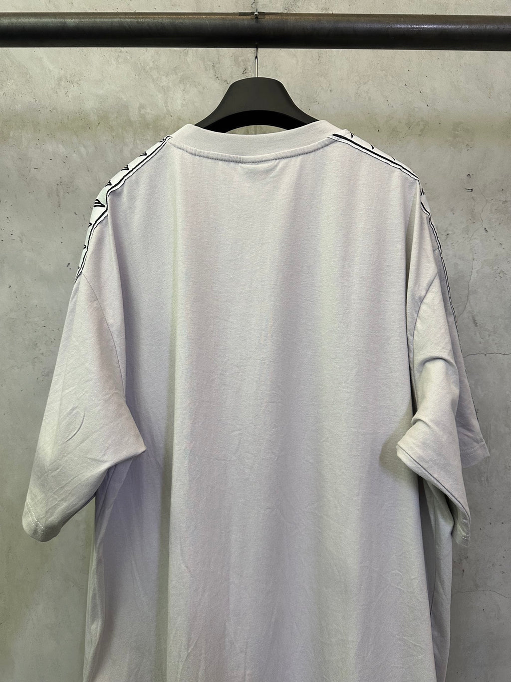 Balenciaga white T-shirt back view with black logo stripe on shoulders