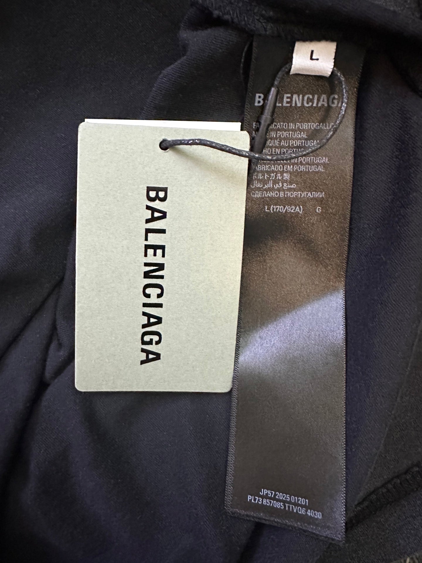 Black T-shirt with BALENCIAGA tags at the collar, including size label