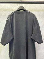 Men's black crew-neck T-shirt, back view with white logo tape on shoulders