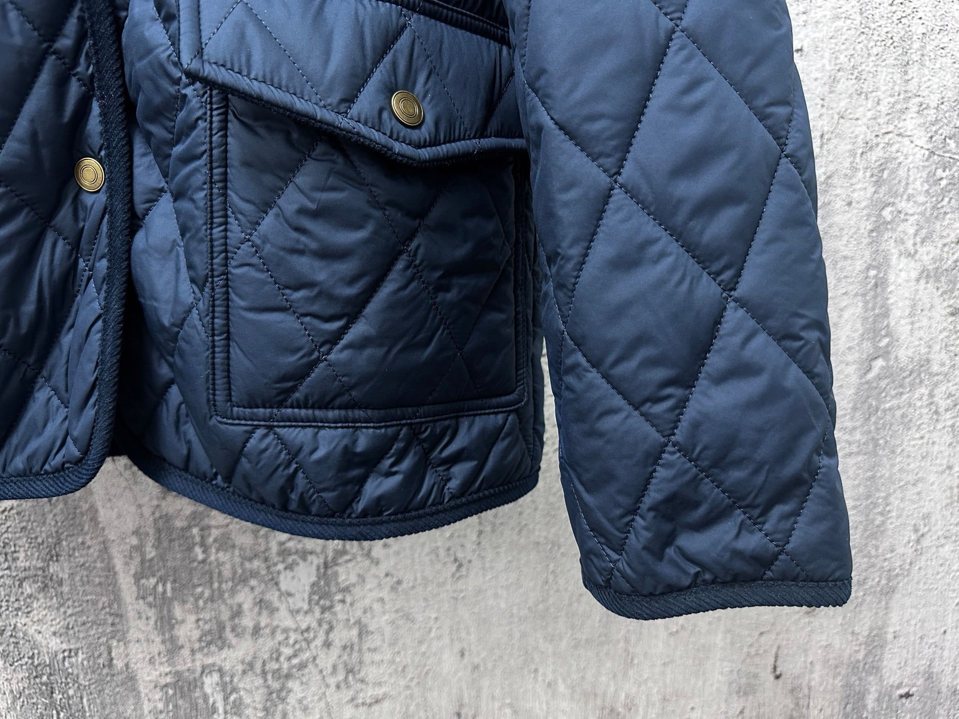Ralph Lauren quilted jacket sleeves and pocket, navy blue, snap flap pocket detail