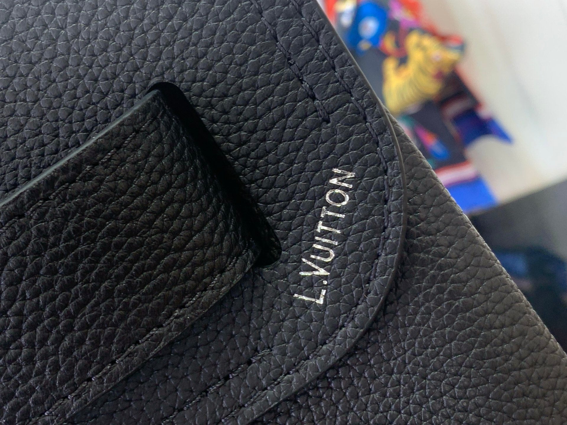 Louis Vuitton leather backpack close-up of interior pocket with embossed logo text