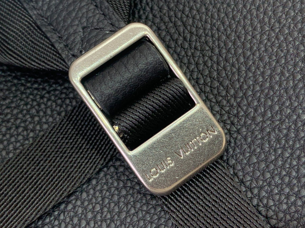 Louis Vuitton backpack close-up of gold-toned buckle on textured leather strap