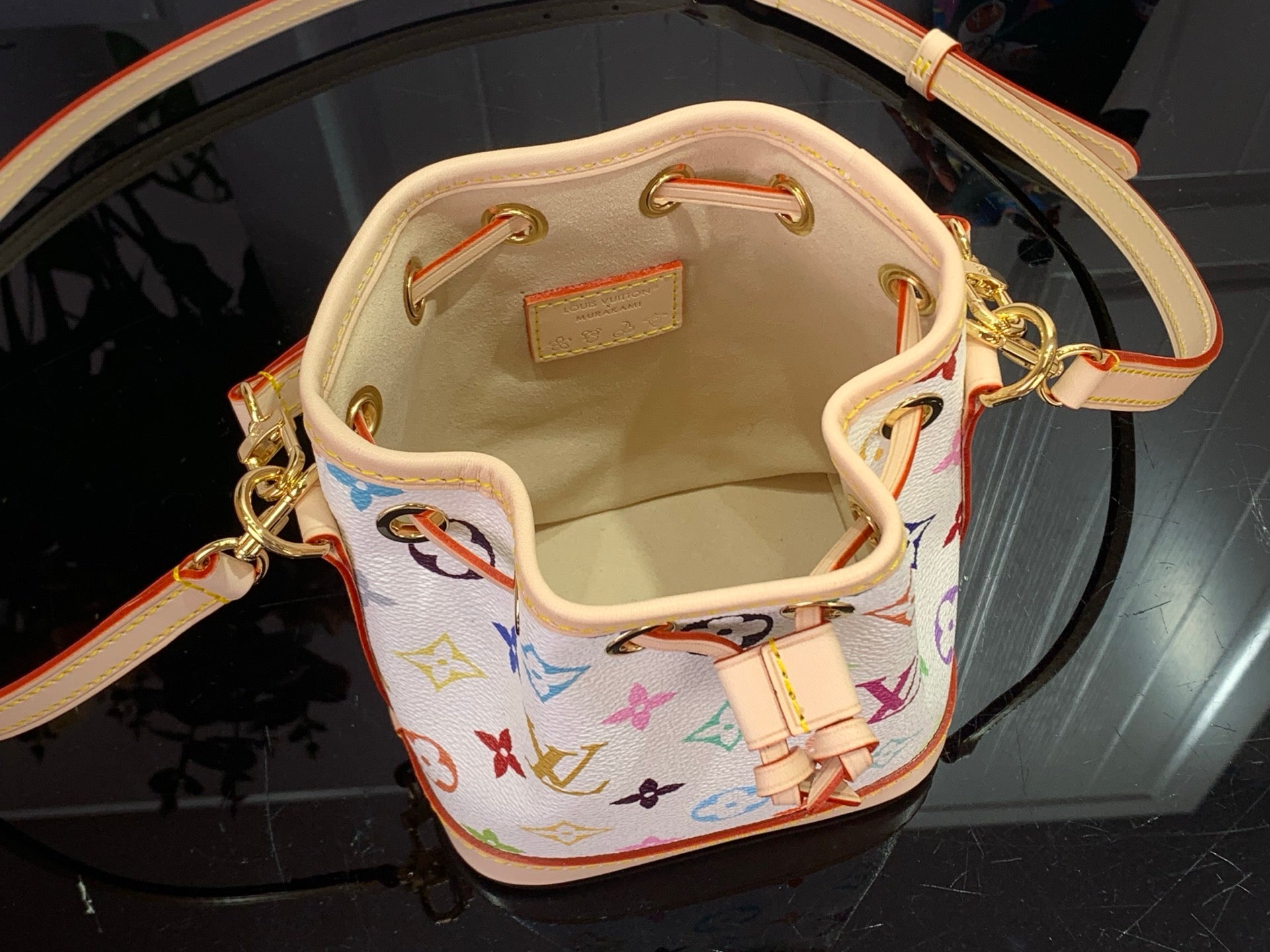 Bucket bag interior with beige lining and gold-tone rings