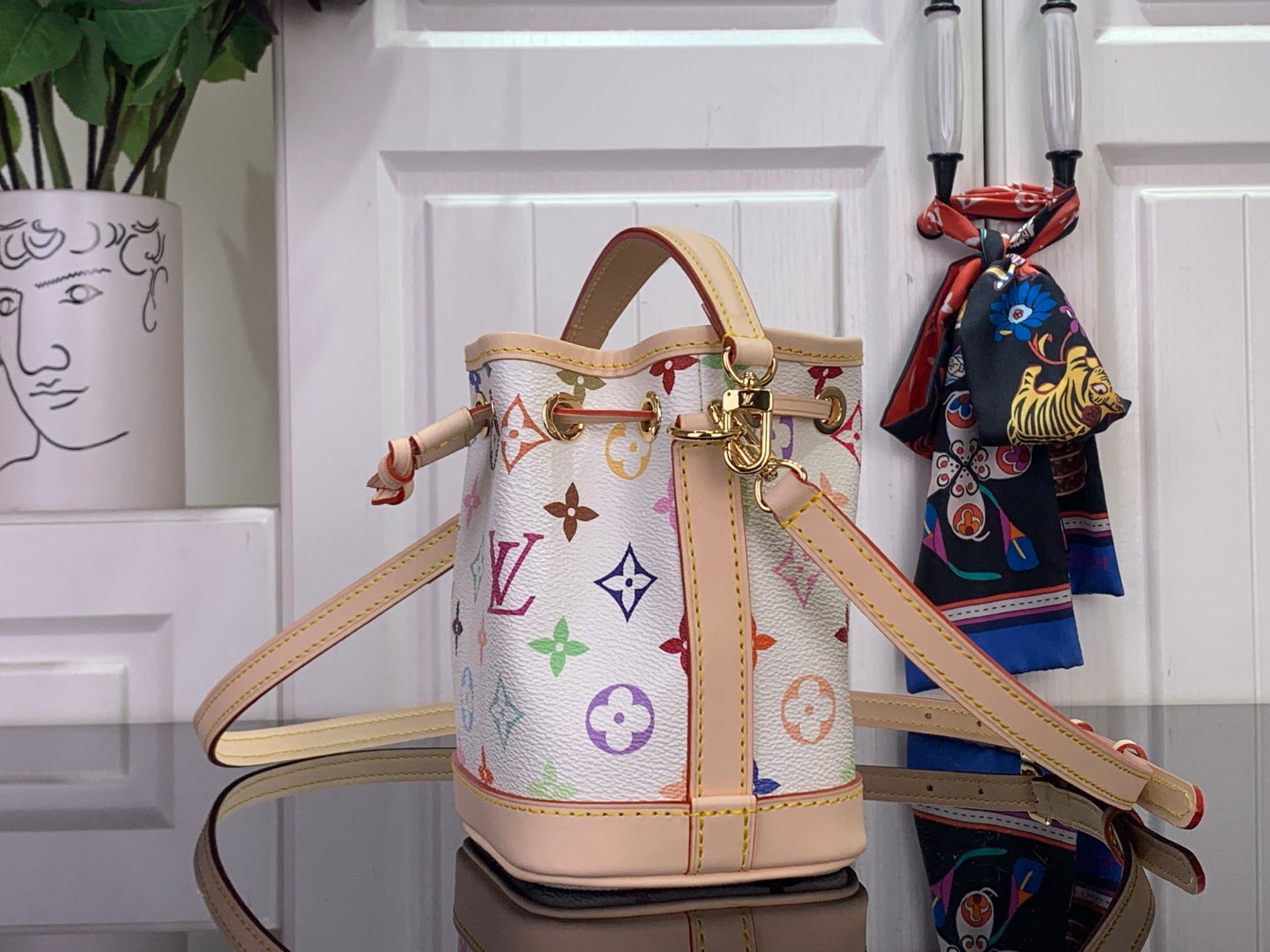 Multicolor monogram bucket bag with leather trim and crossbody strap