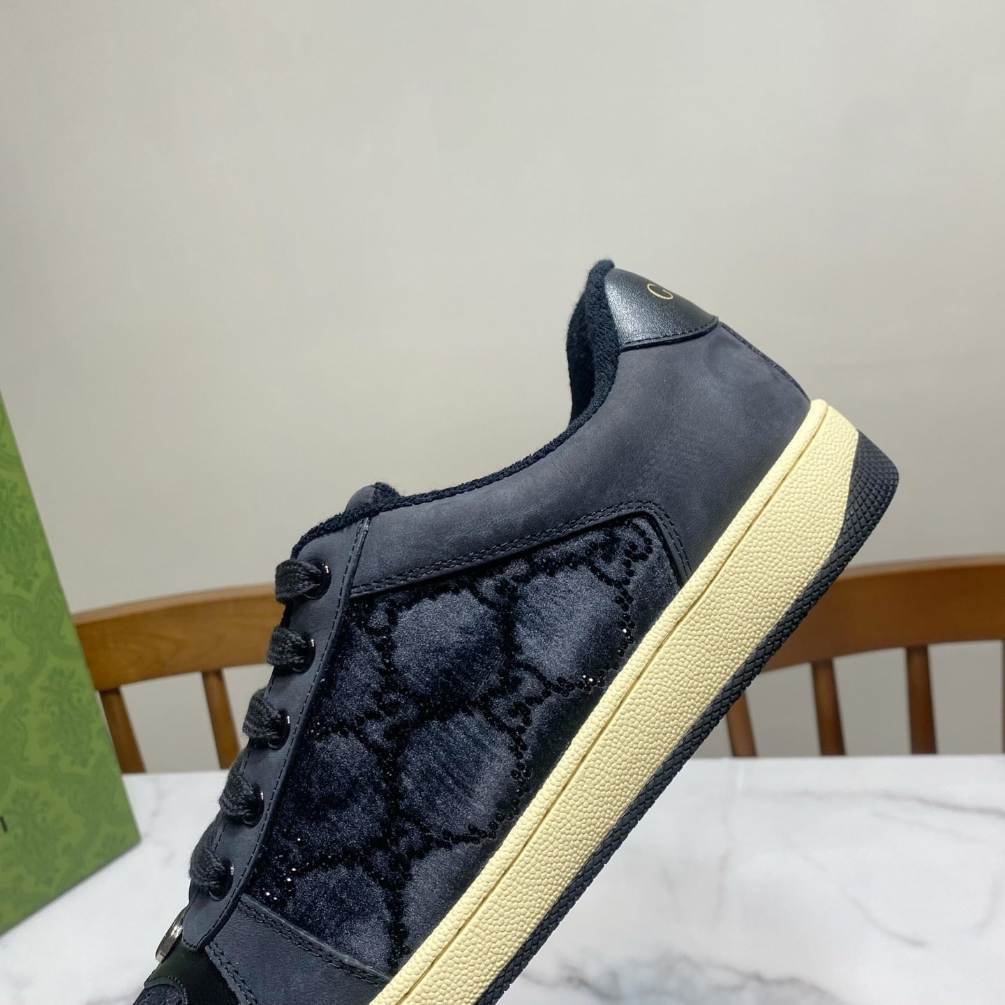 Gucci unisex low-top sneakers in dark navy with textured panels and cream sole.