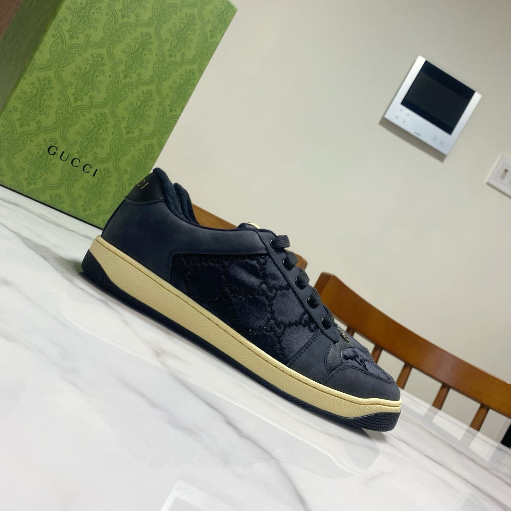 Gucci unisex sneakers, dark navy with lace-up, side panels, and cream edge sole.