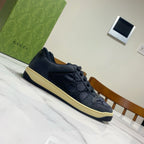 Gucci unisex sneakers, dark navy with lace-up, side panels, and cream edge sole.