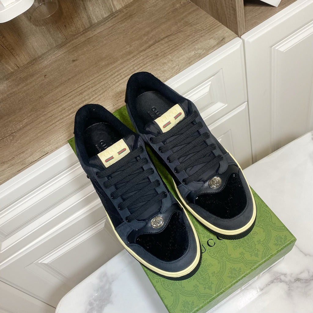 Gucci unisex sneakers, dark navy with lace-up and cream-trimmed rubber soles.
