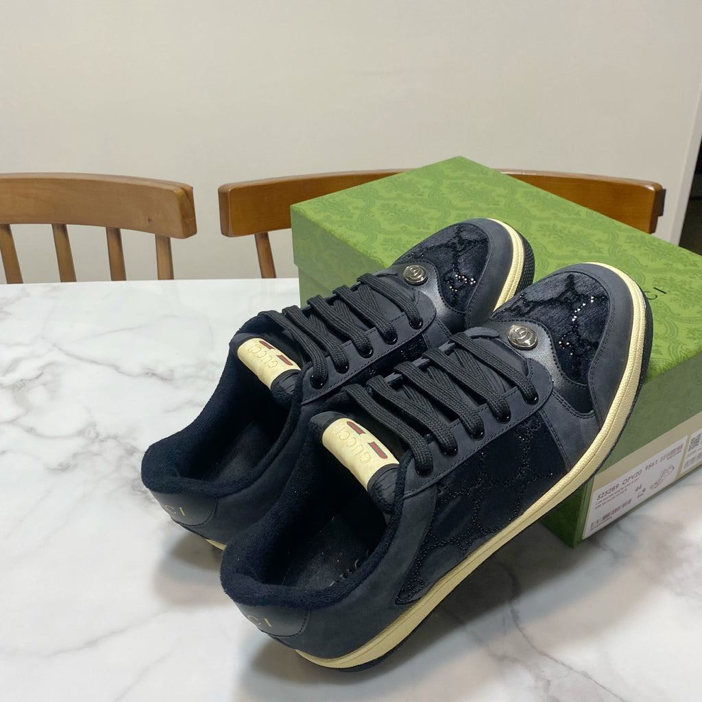 Gucci unisex lace-up sneakers in dark navy with cream toe cap and stitched overlays.