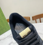 Gucci unisex sneaker heel interior in dark navy with Gucci logo patch.
