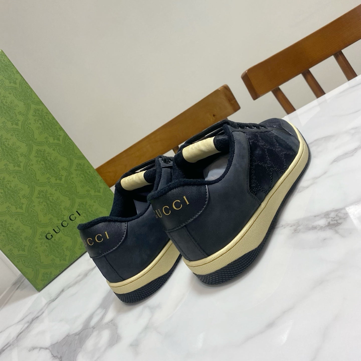 Gucci unisex sneakers pair, dark navy suede with heel tab and lace-up design.