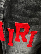 Gray denim fabric close-up with large red 'TR1' lettering