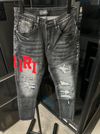 Gray distressed denim jeans with waistband label and red 'TR1' on the side