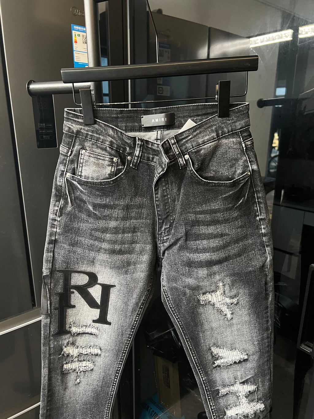 AMIRI logo patch distressed dark denim jeans with belt loops and button fly