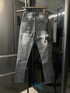 AMIRI logo distressed light-wash denim jeans, back pockets and button fly