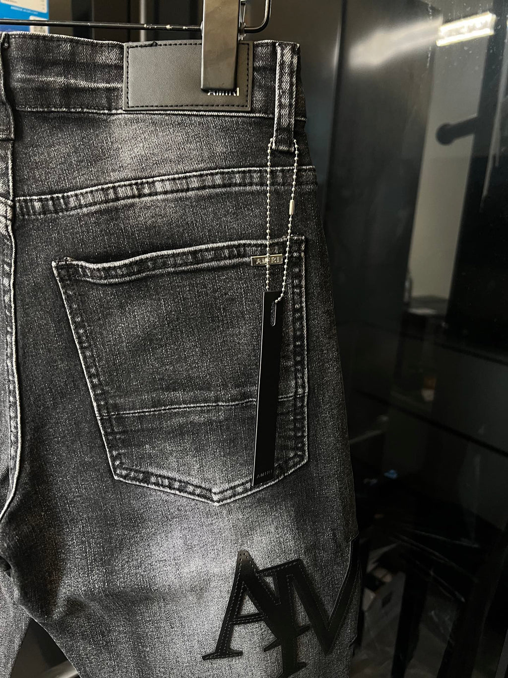 AMIRI dark wash denim jeans with front pocket and stitched coin pocket