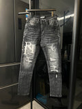 Light-wash distressed denim jeans with large RI patch and frayed knee rips