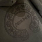 Black embroidered oval face logo on hoodie front