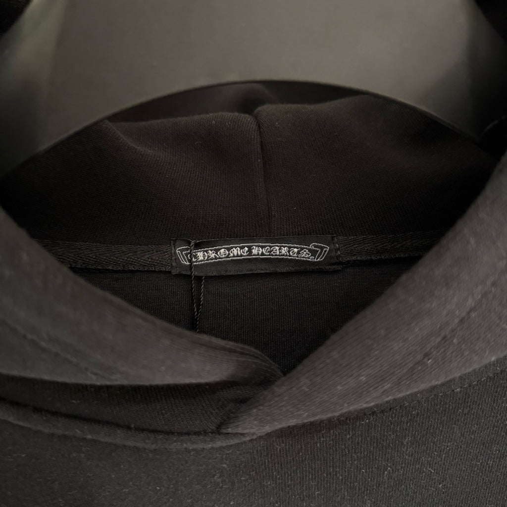 Black hoodie neck label inside collar with hood seam detail