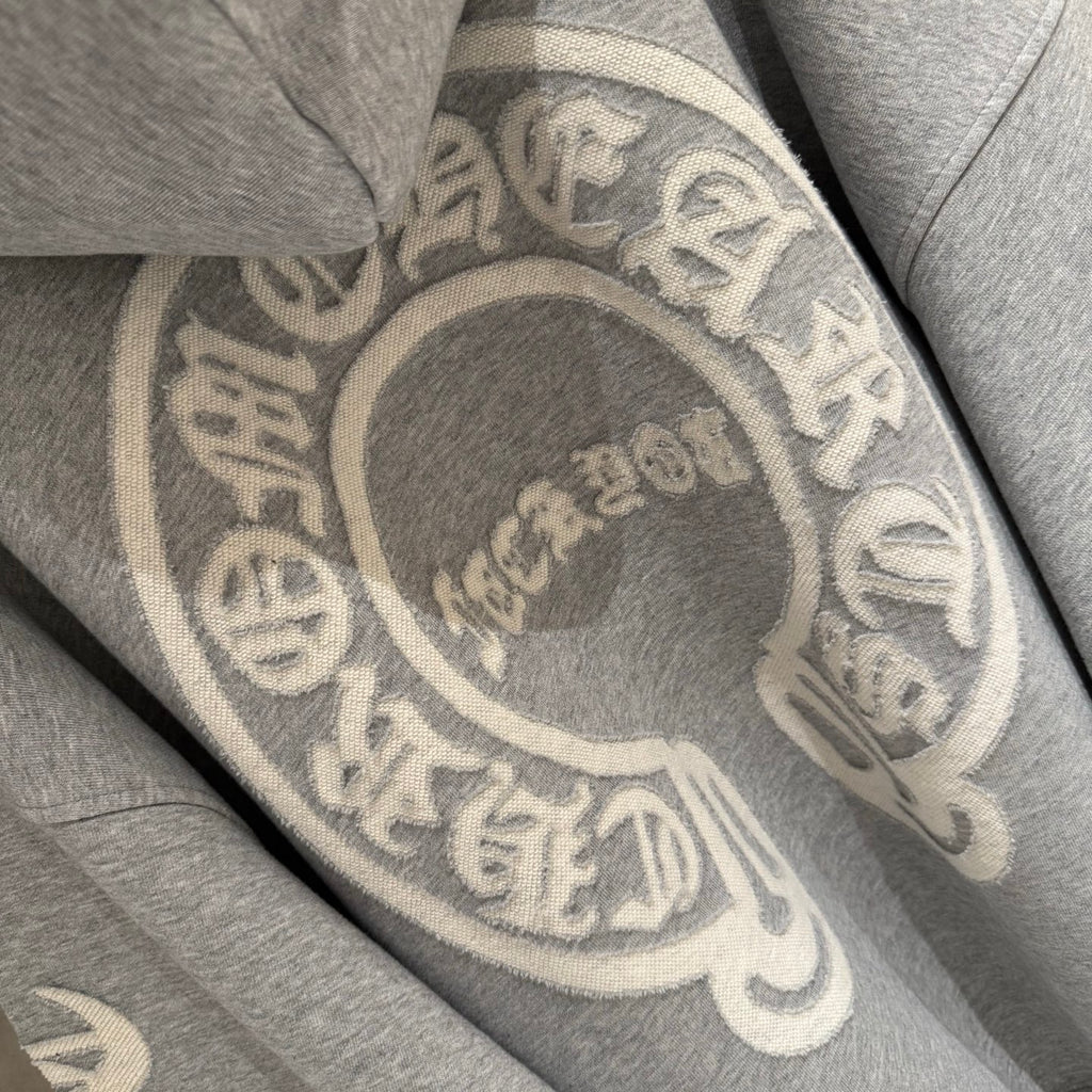 Gray hoodie back with oversized circular emblem graphic.