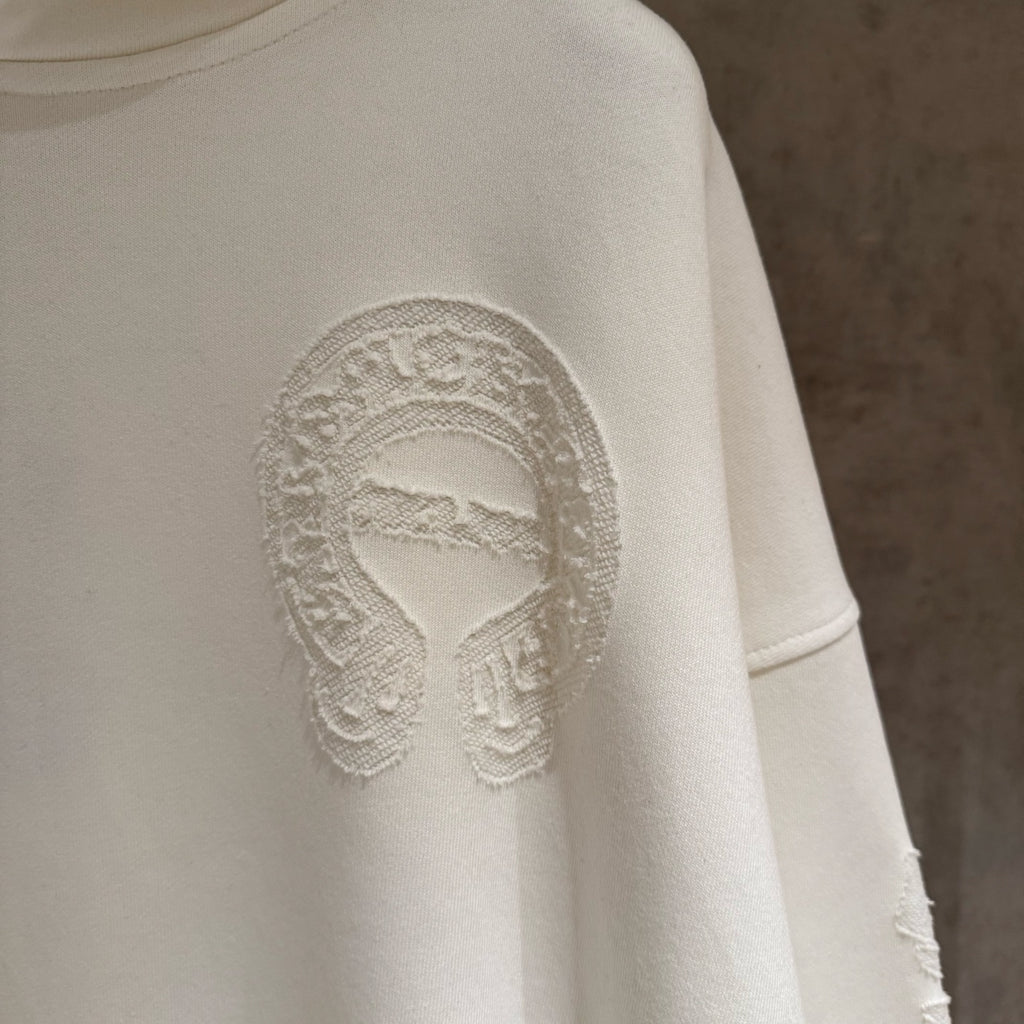 Off-white hoodie sleeve area with embossed face logo print