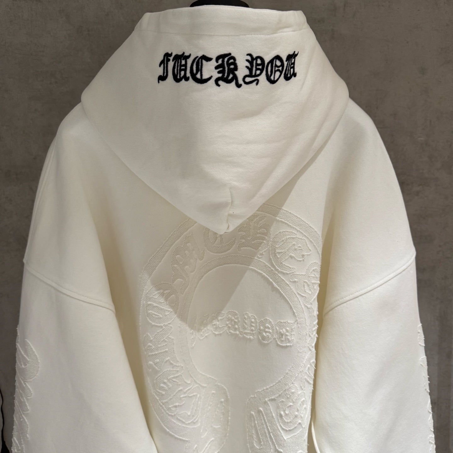 Off-white hoodie back with hood and embroidered text at center back
