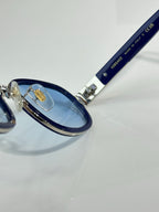Versace sunglasses close-up with blue frame and metal hinge details