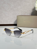 Gold-frame cat-eye sunglasses with dark blue lenses and jeweled bridge