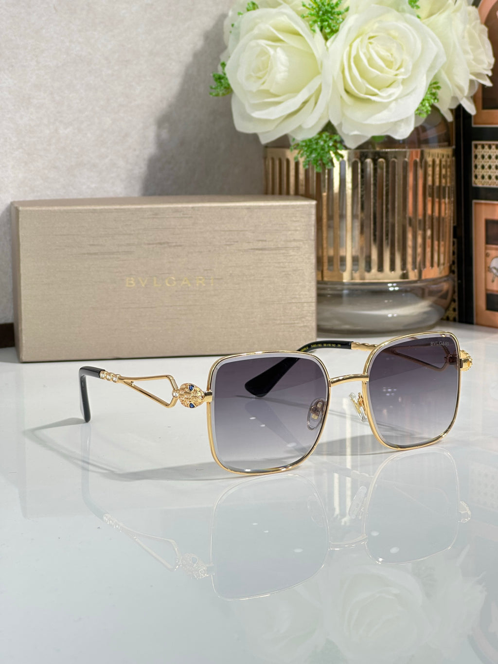 Gold sunglasses with dark purple tinted lenses