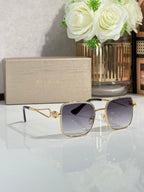 Gold sunglasses with dark purple tinted lenses