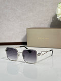 Silver sunglasses with dark lenses and gold-tone logo detail