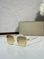 Gold sunglasses with light yellow tinted lenses