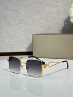 Gold sunglasses with dark navy tinted lenses