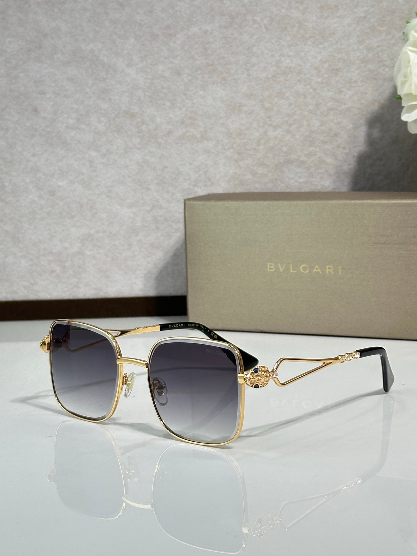 Gold sunglasses with dark navy tinted lenses
