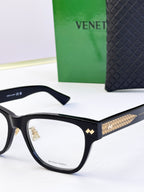 Black eyeglasses front side view with gold-pattern temple accents.